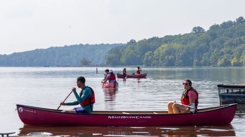 Students in canoe's on the lake. 