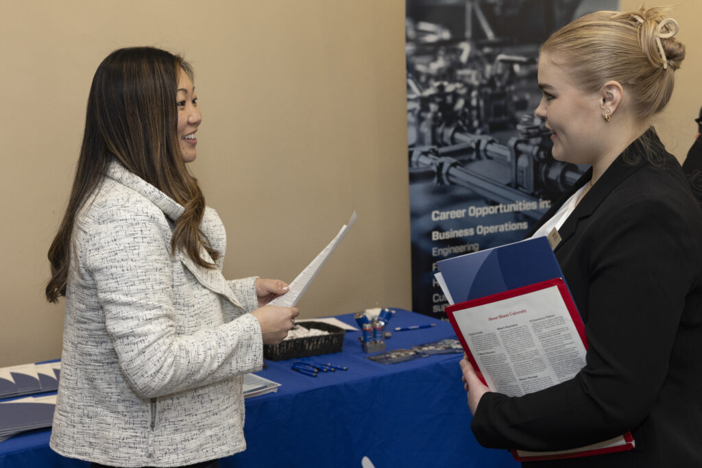 Two women talking with each other at a career fair