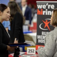 Two women talking with each other at a career fair