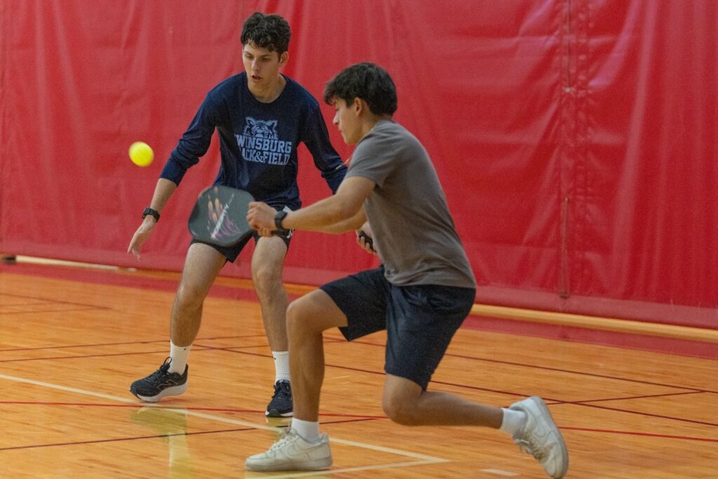 Two boys playing pickleball