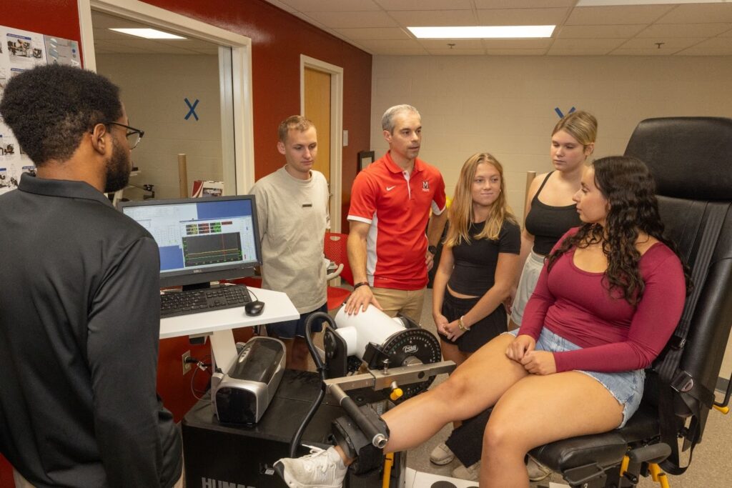 Students using a machine on a students knee