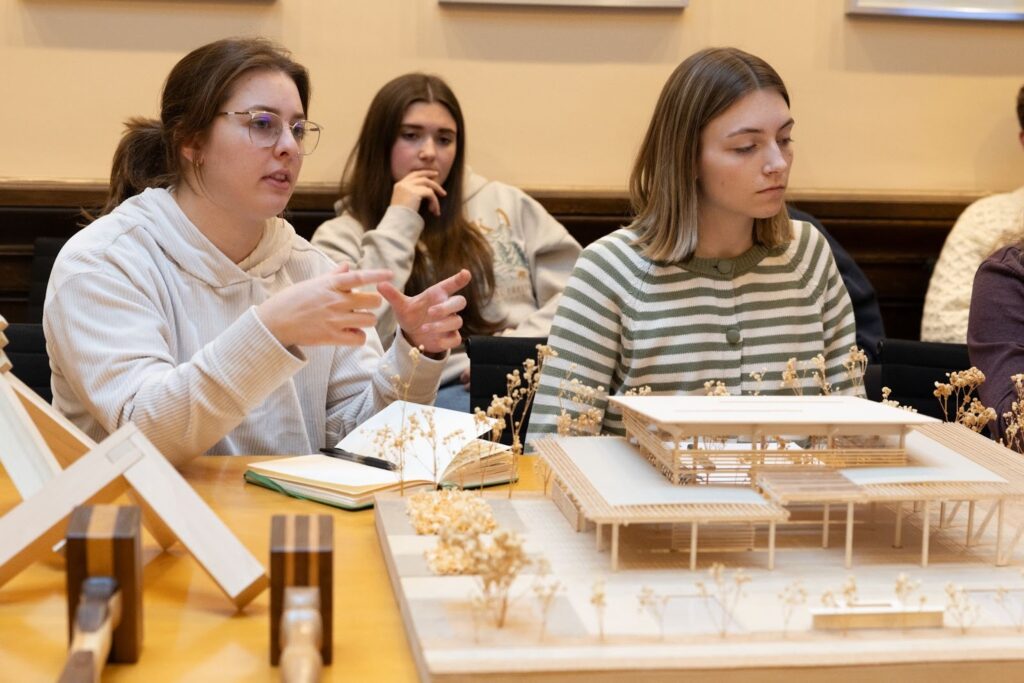 Students in-front of a mini structure they built 