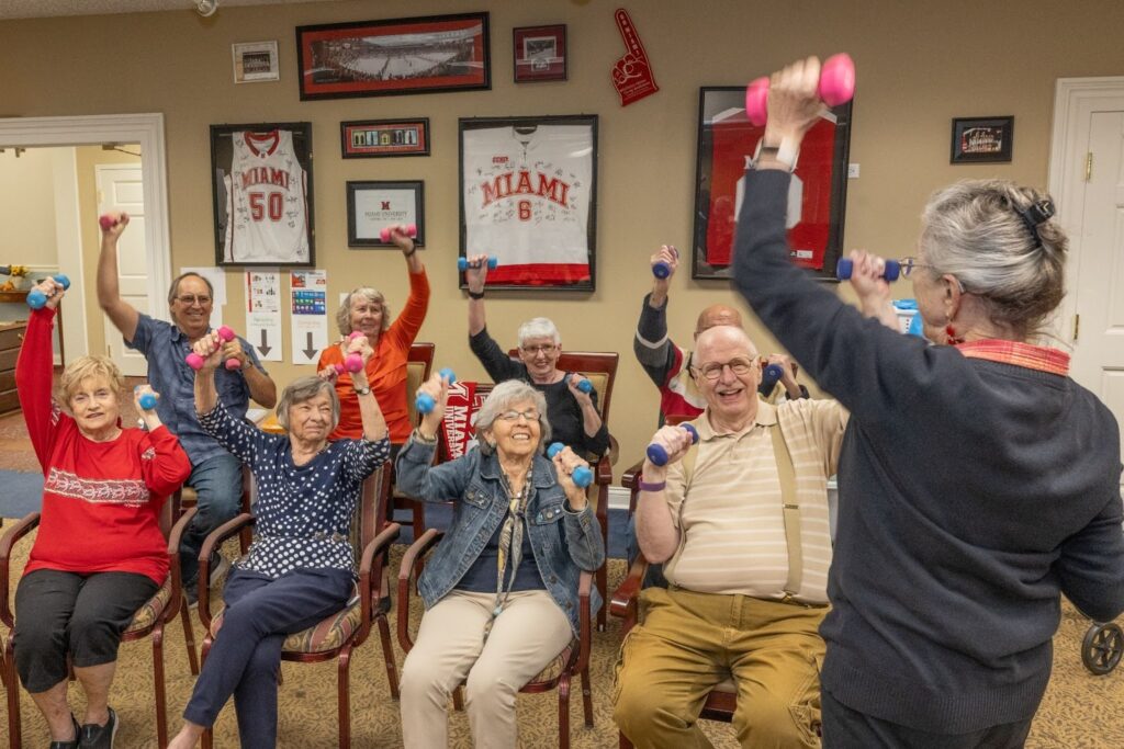 A group of elderly people lifting weights 